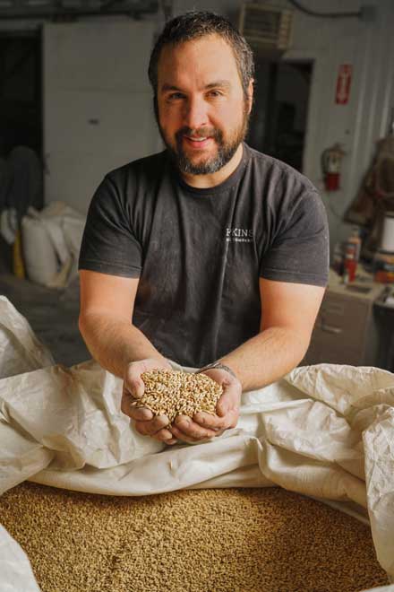 James Weed, of Solstice Malt, holding a handful of malt